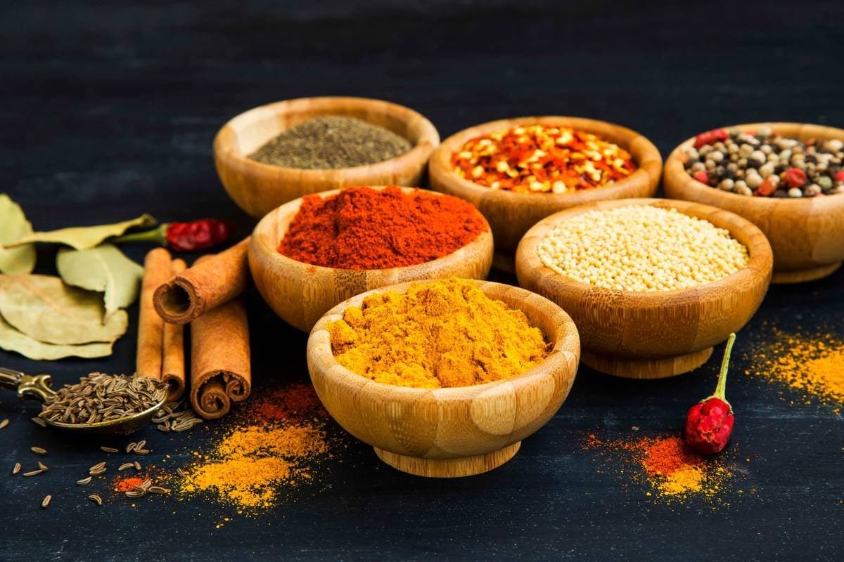 Assorted spices in wooden bowls